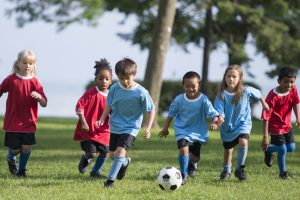 Little Boy Kicking a Soccer Ball