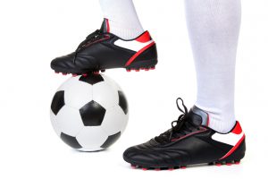 Football player with ball on white